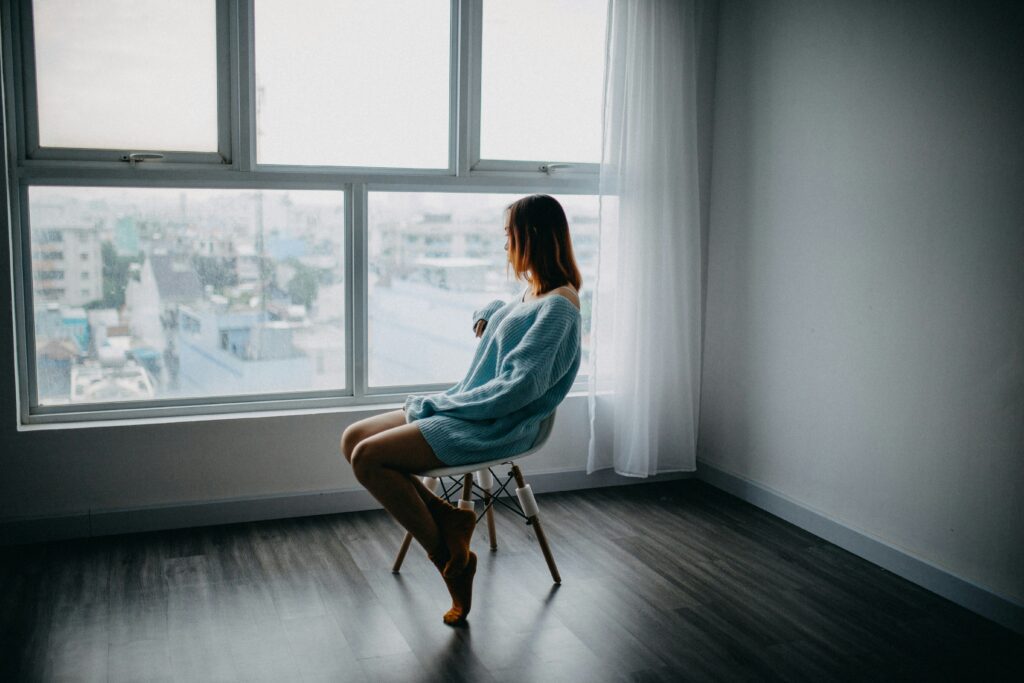 woman looking out the window