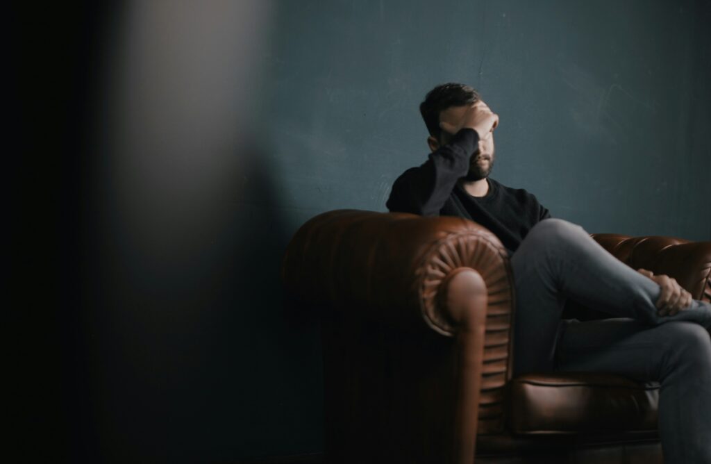 stressed man sitting on a couch