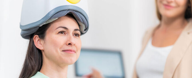 Woman receiving a brain stimulation session, illustrating Transcranial Magnetic Stimulation for process addictions