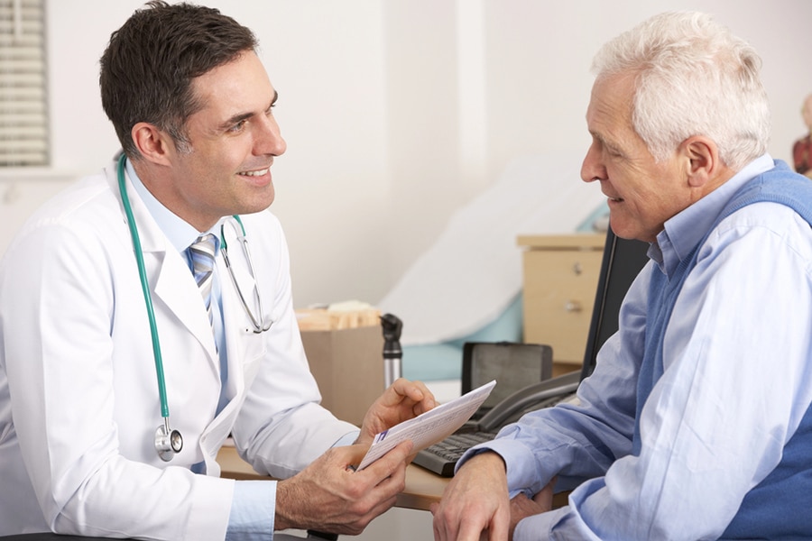 Doctor reviewing a cognitive care plan during a consultation with a senior patient in Phoenix. Doctor reviewing a cognitive care plan during a consultation with a senior patient in Phoenix.
