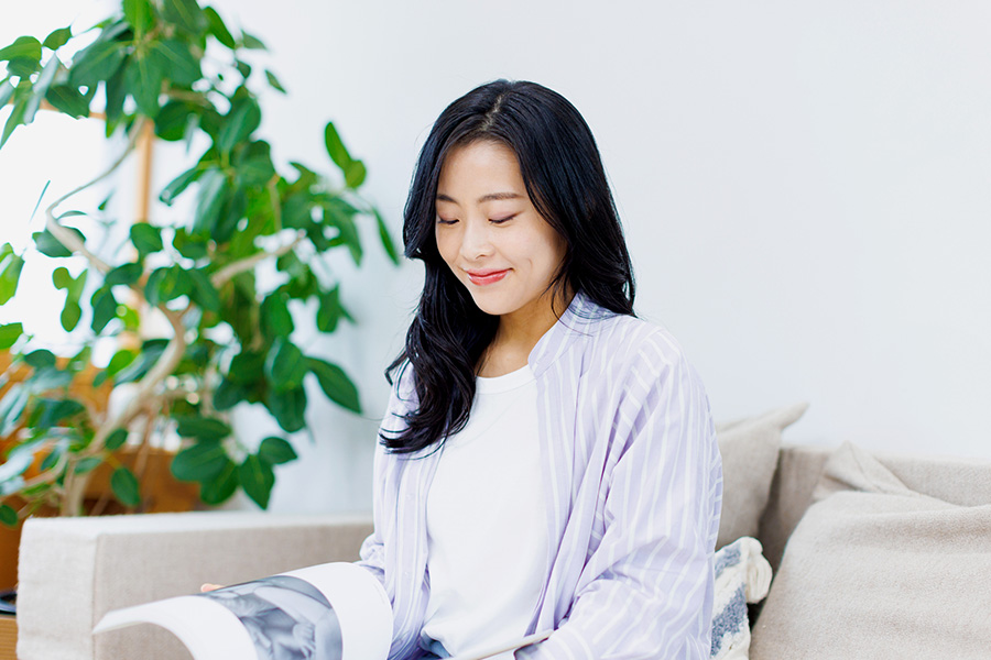 A calm woman relaxing at home, experiencing mood stability after receiving bipolar disorder treatment in Phoenix, AZ.