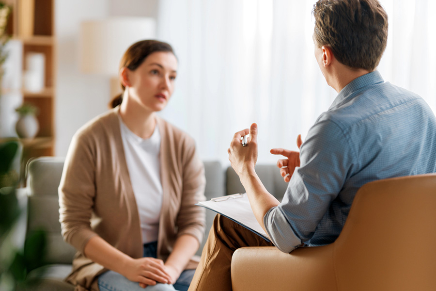 A psychiatric provider conducting a comprehensive evaluation for bipolar disorder by discussing long-term mood patterns with a patient.